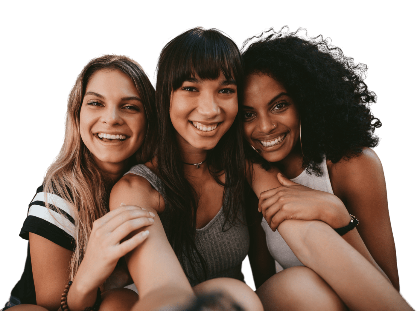 Three young adult women friends embracing each other
