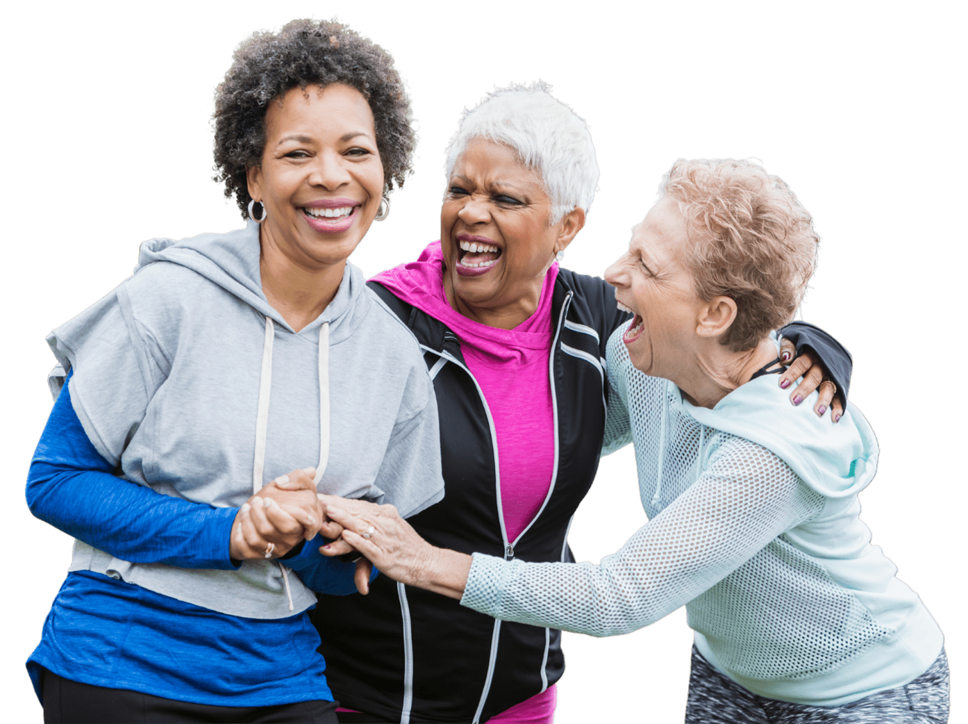 Three senior women in active attire laughing and embracing each other