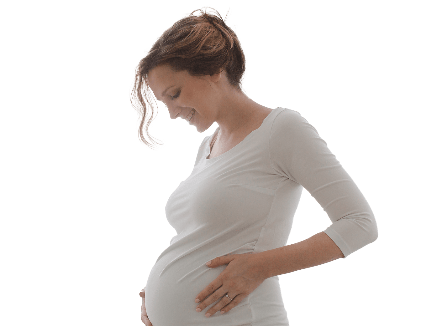 Pregnant woman in long sleeve shirt embracing belly