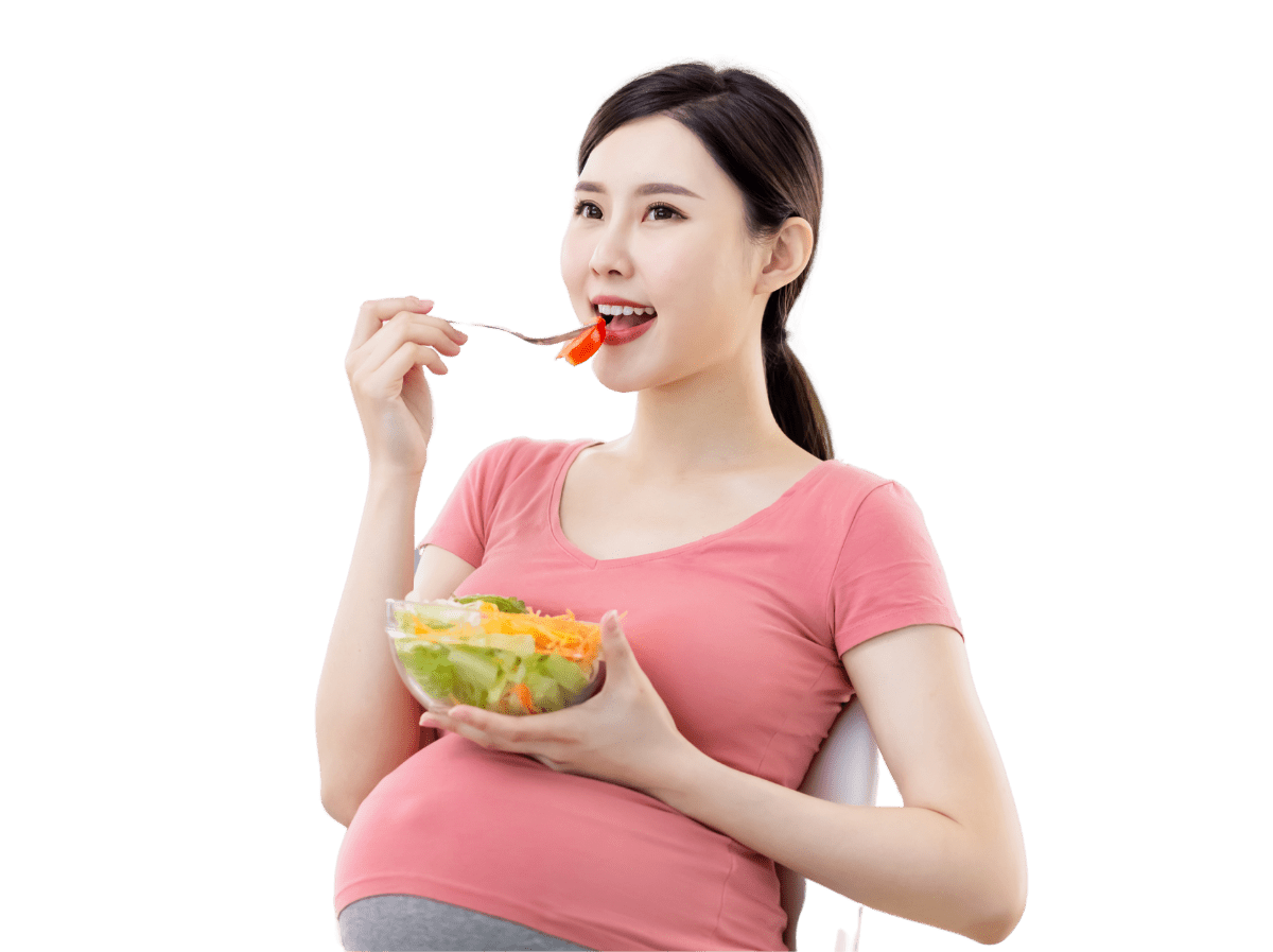 Visibly Pregnant woman eating salad