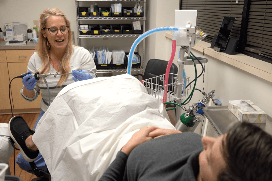 Female doctor performing bladder Botox procedure on female patient 