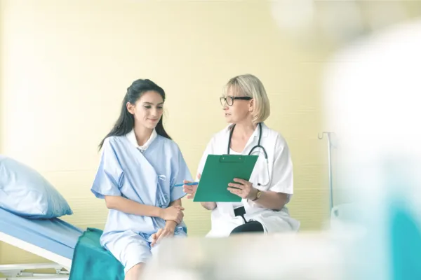 Woman and doctor with clipboard